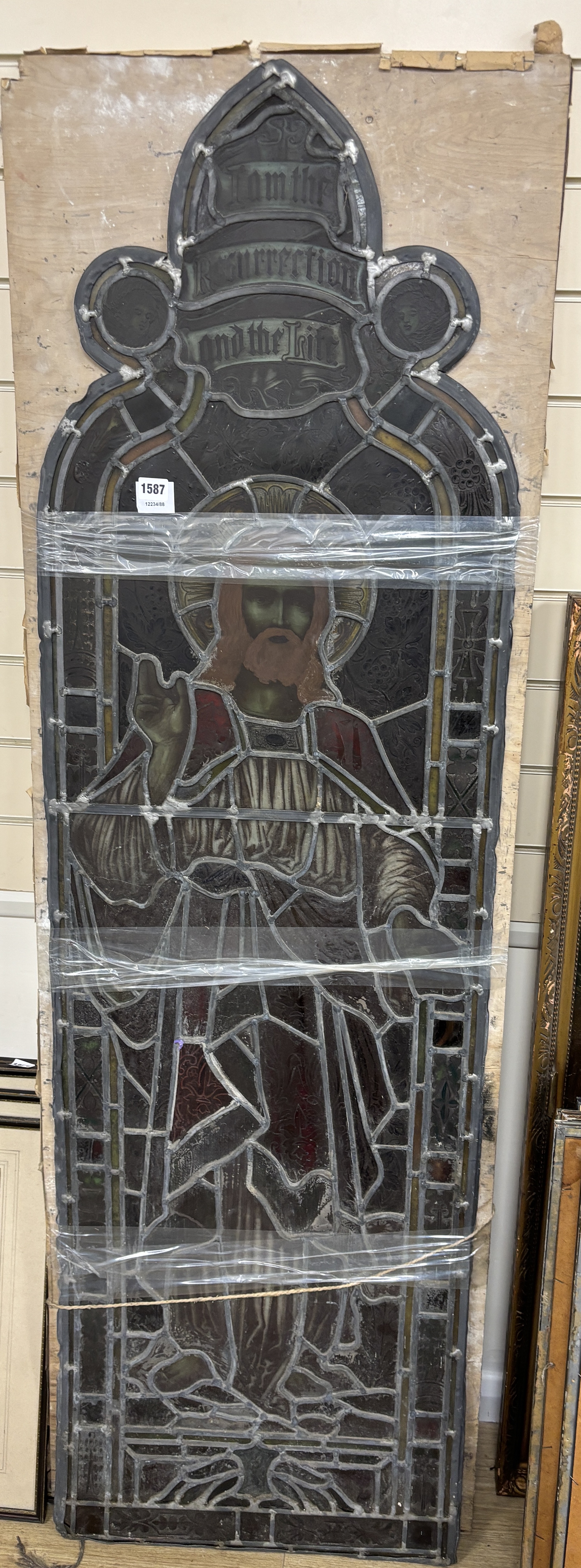 A Victorian stained glass panel depicting Christ ‘I am the resurrection and I am the life’ 170x51cm